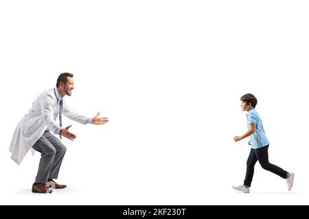 Boy running towards a male doctor isolated on white background Stock Photo