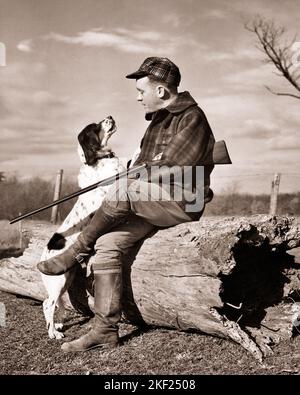 1930s 1940s MAN HUNTER WEARING PLAID JACKET CAP HOLDING SHOTGUN SITTING ON HOLLOW LOG TALKING TO HIS SPRINGER SPANIEL DOG - g2779 HAR001 HARS RURAL NATURE COPY SPACE FRIENDSHIP FULL-LENGTH PERSONS CARING MALES PETS HUNTER PLAID B&W HUNT RESTING HAPPINESS MAMMALS ADVENTURE HIS LEISURE LOG CANINES LOW ANGLE RECREATION FALL SEASON SPRINGER TO POOCH CONNECTION HOLLOW WOOLEN CANINE COOPERATION FIREARM FIREARMS HUNTERS MAMMAL MID-ADULT MID-ADULT MAN SHOTGUNS TOGETHERNESS AUTUMNAL BIRD DOG BLACK AND WHITE CAUCASIAN ETHNICITY FALL FOLIAGE HAR001 HUNTING DOG OLD FASHIONED Stock Photo