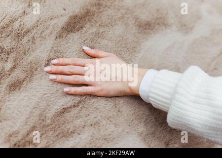 Close up of hand touching soft carpet. Gentle and fluffy carpet between fingers. Stock Photo