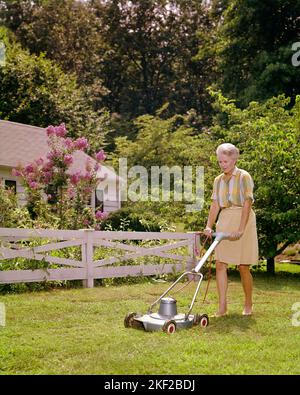1960s SENIOR WOMAN WITH GRAY HAIR WEARING SKIRT AND BLOUSE MOWING LAWN BY WHITE FENCE WITH ELECTRIC MOWER - kg3626 HAR001 HARS MOWING LIFESTYLE SATISFACTION CHORES ELDER FEMALES HOUSES RURAL HEALTHINESS HOME LIFE COPY SPACE FULL-LENGTH LADIES PERSONS RESIDENTIAL BUILDINGS CONFIDENCE SENIOR ADULT MIDDLE-AGED SUMMERTIME SENIOR WOMAN OLD AGE MIDDLE-AGED WOMAN OLDSTERS OLDSTER CHORE LEISURE BLOSSOM AND RECREATION BLOUSE HOMES ELDERS TASKS YARD WORK LAWN MOWER RESIDENCE GRAY LANDSCAPING SEASON TASK CAUCASIAN ETHNICITY HAR001 OLD FASHIONED Stock Photo
