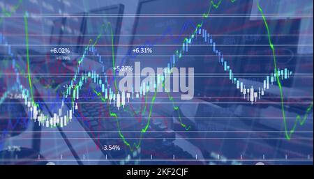 Image of financial data processing against close up of desks at office Stock Photo
