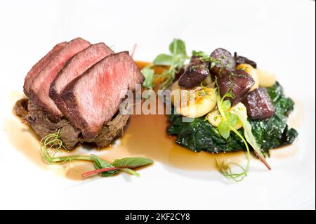Seared beef with potatoes beets and spinach Stock Photo
