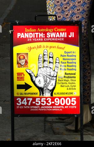 A sign for a Pandit that a 100% result guaranteed. On 74th Street  in Jackson Heights, Queens, New York. Stock Photo