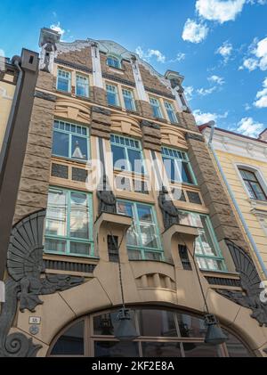 Estonia, Tallinn - July 21, 2022: Historic Art Nouveau gray facade on Pikk 25 street, named 2 Sisters, features sculpted beige gable, 2 women statues, Stock Photo