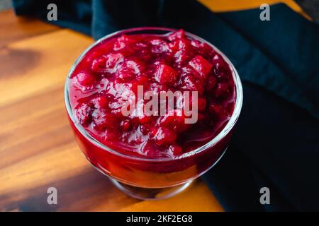 Apple Cranberry Sauce with Cider & Cinnamon in a Small Glass Dish: Cranberry sauce made with apples and cinnamon Stock Photo