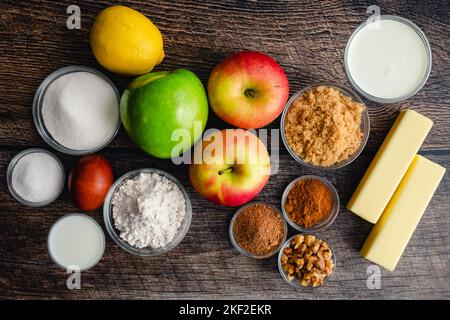 Salted Caramel Apple Galette on a Wood Background: Fresh apples, flour, and other raw ingredients viewed from above Stock Photo