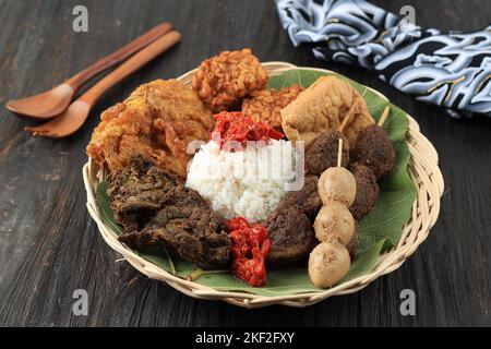 Nasi Jamblang or Sega Jamblang, Cirebon Mix Rice Wraooed with Teak Leaf. Served  with Various Side Dish. Stock Photo