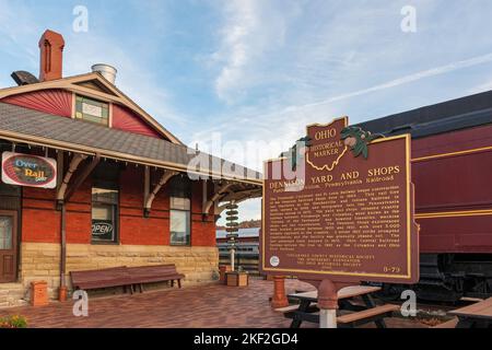 Dennison, Ohio, USA- Oct. 24, 2022: Historical marker about Dennison Railyard with the Dennison Railroad Depot Museum in the background. Stock Photo
