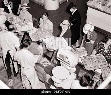 1940s WOMEN IN GROCERY STORE SHOPPING AT BUTCHER DEPARTMENT WITH ALL MALE BUTCHERS HELPING BEHIND THE COUNTER - s4184 HAR001 HARS FEMALES COPY SPACE HALF-LENGTH LADIES PERSONS SHOPS MALES MEAT BUTCHER MIDDLE-AGED B&W MIDDLE-AGED MAN SHOPPER DRESSES HOMEMAKER SHOPPERS SELLING HOMEMAKERS MIDDLE-AGED WOMAN HEAD AND SHOULDERS HIGH ANGLE ADVENTURE CUSTOMER SERVICE BUTCHERS EXCITEMENT POLKA DOTS HOUSEWIVES OCCUPATIONS PORK STORES BACON COMMERCE COOPERATION FROM ABOVE MID-ADULT MID-ADULT MAN MID-ADULT WOMAN SALESMEN SAWDUST BLACK AND WHITE BUSINESSES CAUCASIAN ETHNICITY HAR001 OLD FASHIONED Stock Photo