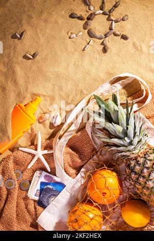 Concept of sandy beach holiday, top view, drawing on the sand in the form of a sun and seagulls made of shells, flat lay Stock Photo