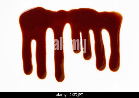 Melted chocolate dripping on white background Stock Photo
