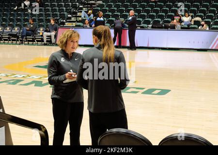 Washington State University women's basketball head coach Kamie Ethridge speaking with an assistant before a game against University of San Francisco. Stock Photo