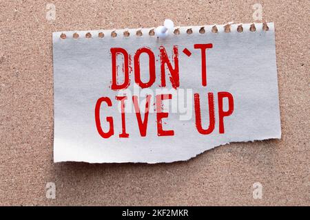 Dont give up word written in pen notebook. Stock Photo