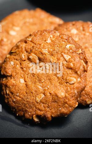 Anzac biscuits are a sweet biscuit, popular in Australia and New Zealand, made using rolled oats, flour, sugar, butter, golden syrup, baking soda, boi Stock Photo