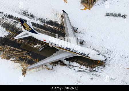 Singapore Airlines Cargo Boeing 747-400F cargo aircraft parked on snow. Airplane for freighter transport of Singapore Cargo. Plane 747 in winter. Stock Photo