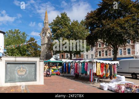 Clock tower and clothing stall, The Market Square, Aylesbury, Buckinghamshire, England Stock Photo