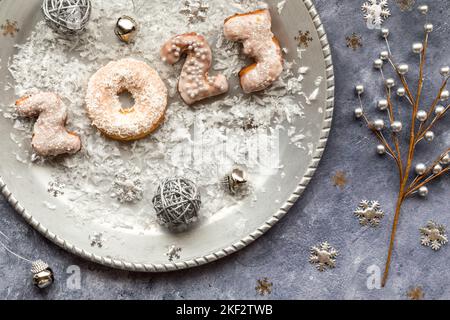 A silver platter with 2023 donuts to celebrate the New Year. Stock Photo