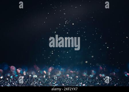 Defocused black glitter texture with iridescent bokeh and snow in the dark Stock Photo
