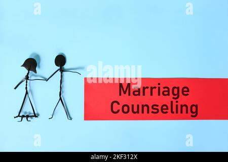 Marriage counseling concept. Couple stick figure on blue background. Stock Photo