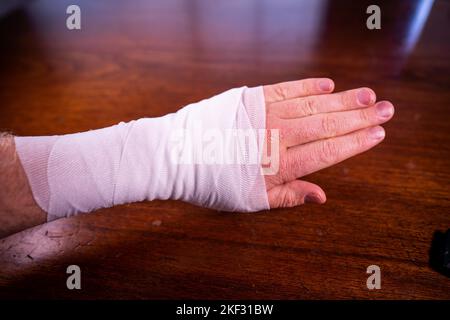 bandaging an arm from a snake bite in australia Stock Photo