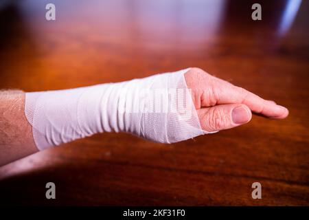 bandaging an arm from a snake bite in australia Stock Photo