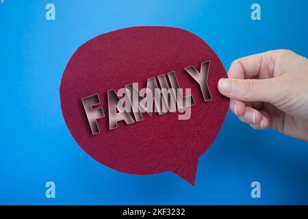 Speech bubble in front of colored background with Family text. Stock Photo