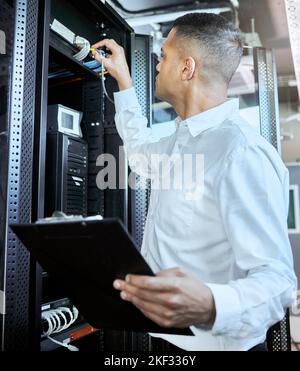 Information technology, server and man engineer with clipboard working, fixing and checking motherboard. Programming, cyber network and IT technician Stock Photo
