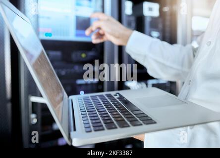 Server room, network and laptop with businessman in data center for engineering, technology and cloud computing. Cybersecurity, internet and mining Stock Photo