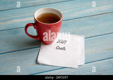 New year 2023 goals on napkin, next to cup of coffee. High angle view. Stock Photo