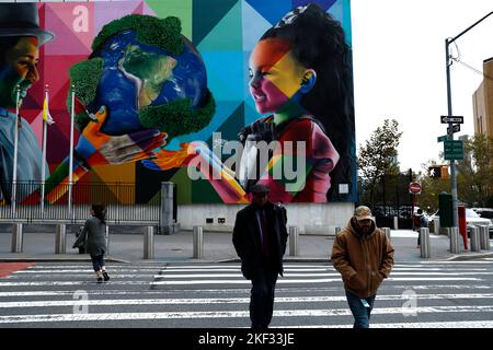 People walk past a mural on the face of the United Nations Headquareters by street artist Kobra on November 15, 2022 in New York City, USA.There are now 8 billion people on earth according to a new United Nations report. While the statistic is notable, actual factors contributing to the increase are due to a number of factors not the list of which is the world migration and increased longevity. If the current trends continue, it is expected that the global population could reach 9 billion in the next 15 years. (Photo by John Lamparski/SIPA USA). Stock Photo