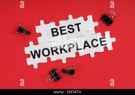 Business and Economics. On a red background, there are puzzles with the inscription - Best Workplace Stock Photo