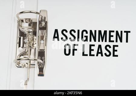 Finance and economics concept. In the folder under a paper clip there is a white sheet with the inscription - Assignment of lease Stock Photo