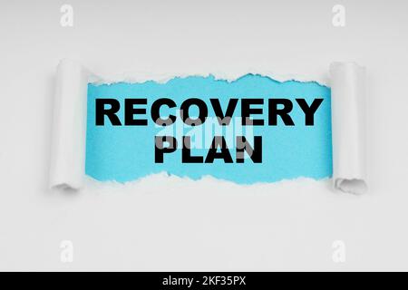 Medical concept. In the middle of a white sheet in space on a blue background the inscription - RECOVERY PLAN Stock Photo