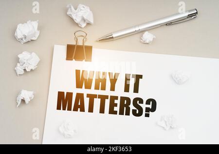Economy and business concept. On a gray surface, a pen, crumpled paper and a sheet with the inscription - WHY IT MATTERS Stock Photo