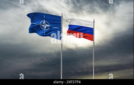 Flags of NATO and Russia on the wall with big crack in the middle. Relationships between North Atlantic Treaty Organisation and Stock Photo