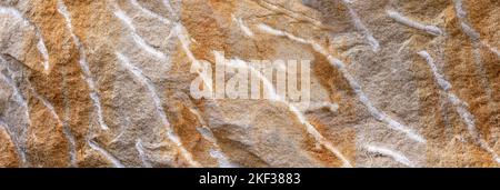Rough uneven sandstone surface in gray and brown with white lines Stock Photo