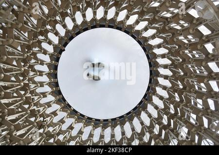 A side view upwards of The Hive at Kew Gardens in London. An intricate circular symmetrical metal structure. Stock Photo