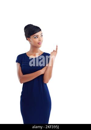 Things are looking up. a young businesswoman pointing upward against a white background. Stock Photo