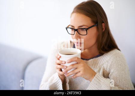Coffee contemplations...a young woman having coffee at home. Stock Photo