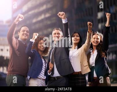 Celebrating their success. a group of excited businesspeople in the city. Stock Photo
