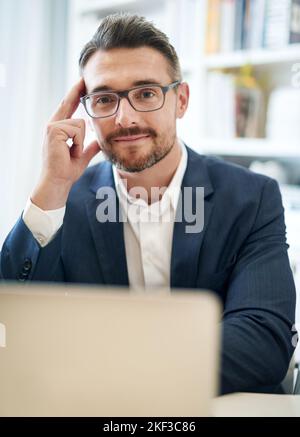 Managing his business like a pro. Cropped portrait of a businessman working in his office. Stock Photo