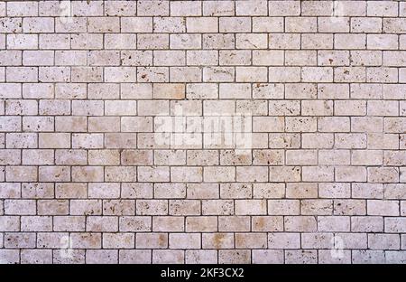 Stone decorative masonry wall background. Bricks made of natural stone surface backdrop. Design, decor, copy space. High quality photo Stock Photo