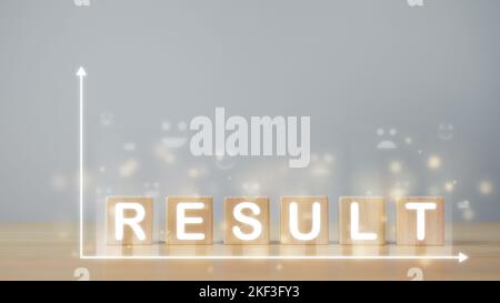Comparison result concept. Wood blocks with text that means RESULT. There are virtual screens such as Emoji face, White line axis and Bokeh. Stock Photo