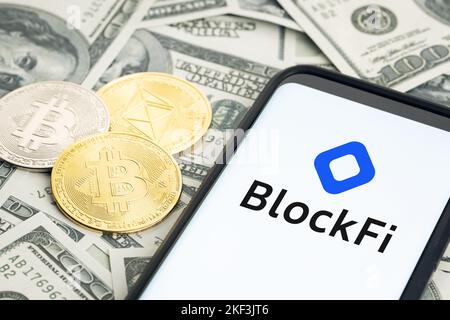 Galicia, Spain; january 28, 2022: Smartphone screen showing Blockfi logo on dollar banknotes and crypto coins Stock Photo