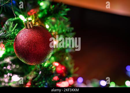 A red bauble on Christmas tree Stock Photo