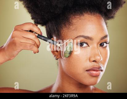 Black woman, face roller and portrait of beauty, rose quartz cosmetics ...