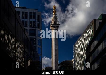 An unusual and dramatic photo of the Monument with superb reflections in an office block on both sides of the street. Stock Photo