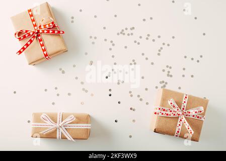 Three gift box on white background with confetti. Flat lay copy space Stock Photo