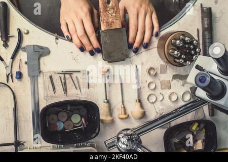 Close up jeweller workspace arrangement concept photo. Craftsmanship. Top view photography with instruments on background. High quality picture for wa Stock Photo