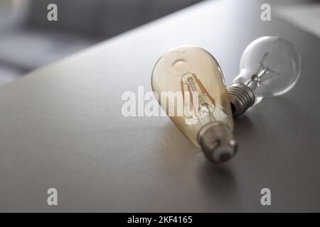 Power energy saving concept. light bulb with light on on gray background. Stock Photo